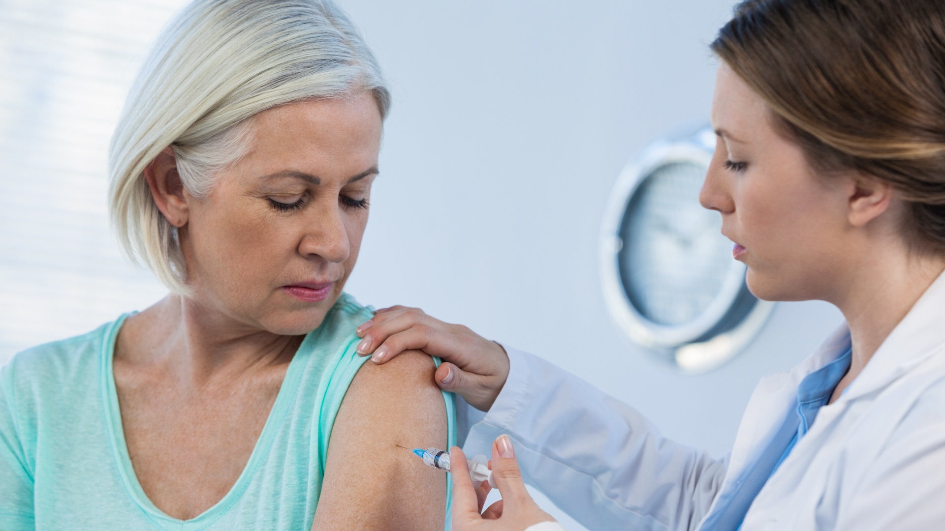 Doctor giving injection to patient